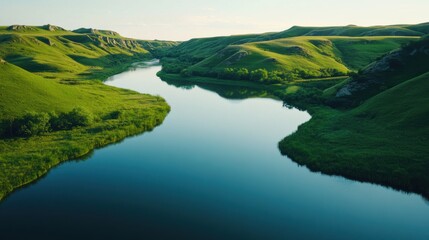 Naklejka premium A wide shot of a tranquil river winding through a lush valley,