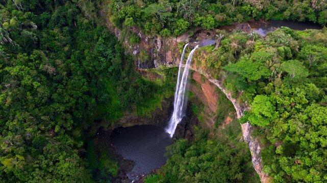 Scenic footage of Chamarel Waterfall cascading through the tropical forest, highlighting the natural beauty of Mauritius. Ideal for nature lovers. Drone footage