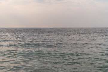 Blue sea surface with to the horizon. Sea waves with cloudy sky. Abstract background of water flow in ocean, sea, river, lake. Seascape wallpaper.