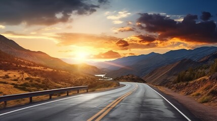 A curvy road winds through the mountains in sunset