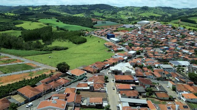 dolly reverse aerial view of Bueno Brandao, an agriculture city in Serra da Mantiqueira, Minas Gerais, Brazil
