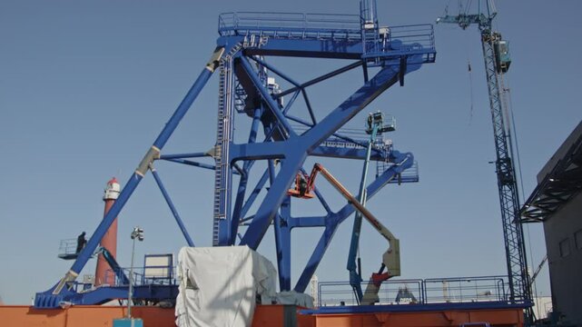 Beautiful tilt up of a pre-piling template being constructed at a dock in a harbor. The piling template will be used to place offshore wind turbines in deep water