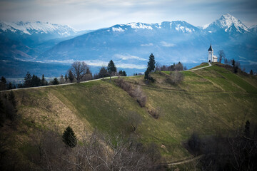 The path to prayer: narrow lane leading out to dramatic site of church in Slovenia