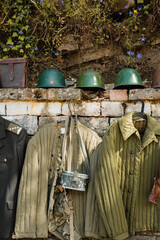 Exhibition of old military uniforms with helmet, jacket, bags, Albania