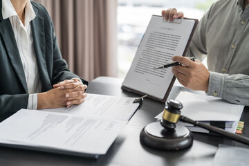 Lawyer Legal counsel presents to the client a signed contract with gavel and legal law. justice and lawyer Business partnership meeting concept