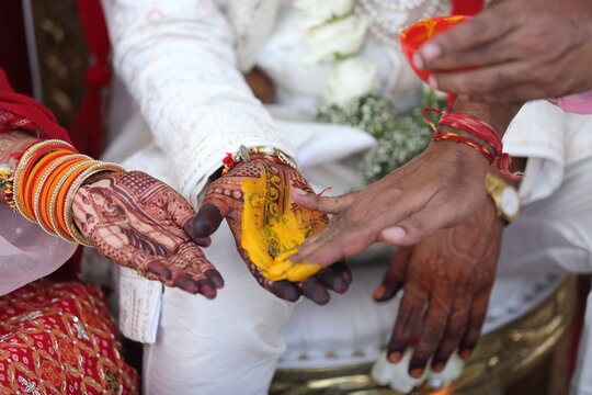 Indian wedding ritual where turmeric paste is applied to the bride's and groom's hands, symbolizing purity, prosperity, and blessings for their new journey together.