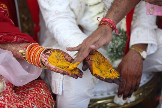 Indian wedding ritual where turmeric paste is applied to the bride's and groom's hands, symbolizing purity, prosperity, and blessings for their new journey together.