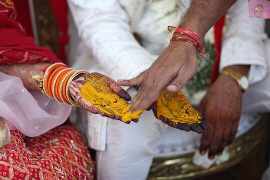 Indian wedding ritual where turmeric paste is applied to the bride's and groom's hands, symbolizing purity, prosperity, and blessings for their new journey together.