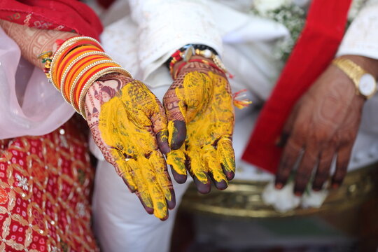 Indian wedding ritual where turmeric paste is applied to the bride's and groom's hands, symbolizing purity, prosperity, and blessings for their new journey together.