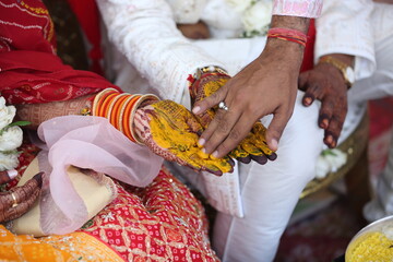 Indian wedding ritual where turmeric paste is applied to the bride's and groom's hands, symbolizing purity, prosperity, and blessings for their new journey together.