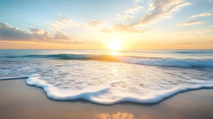 Fototapeta premium A beach with gentle waves rolling in as the sun rises over the horizon