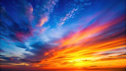 Fototapeta premium Gradual transition from deep blues to vibrant oranges and pinks in a sunset sky, natural, clouds