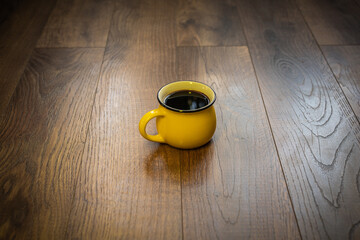 Coffee in a cup on a wooden surface