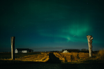 Aurora borealis above Icelanding farm on the night sky