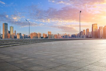 Empty square floor with modern residential area buildings scenery at sunset. car background.