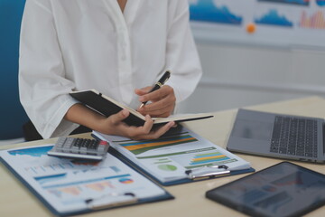 Fototapeta premium Business Documents, Auditor businesswoman checking searching document legal prepare paperwork or report for analysis TAX time,accountant Documents data contract partner deal in workplace office