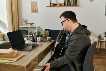 A young man with Down syndrome enjoys strumming his guitar in a warm, inviting space.