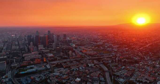 Orange and red light in the scenery of stunning Los Angeles, California, USA. Aerial perspective on the busy midtown and uptown at sunset.