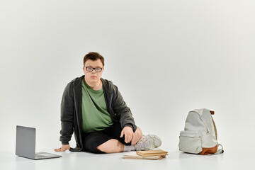 A young man with Down syndrome engages with his homework in a cozy home setting.