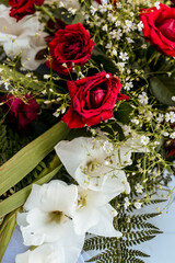 A bouquet of red roses and white flowers that serve as a wedding decoration