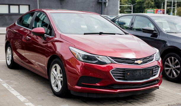 Chevrolet Cruze a compact car parked in street.