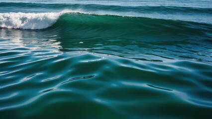 Fototapeta premium Serene ocean waves gently crashing on the shore, reflecting sunlight. Perfect for beach and nature-themed projects