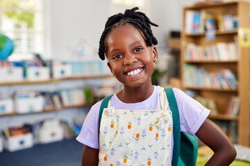 Happy smiling black girl looking at camera at school