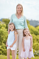 Happy, portrait and mother with girls, daughter and hug in nature, park and summer for holiday. Smile, love and woman embracing children with care for vacation, adventure or weekend break for family