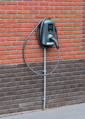 electric car charger on brick wall