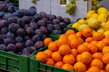 Various stacks of fruit lie on the table for sale at the market