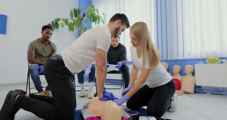 Stay away moment during the defibrillation process on a first aid group training indoors. CPR course using automated external defibrillator device - AED.