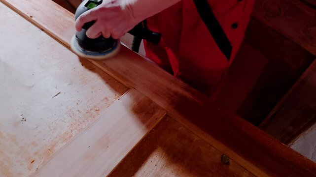 Process of sanding large wooden surface with electric sander