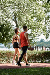 Obraz premium Two friends enjoying an outdoor workout, showcasing strength and camaraderie in a sunny park.