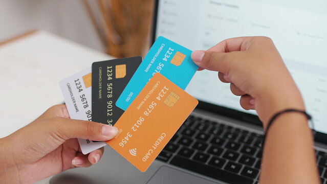 A person holding a credit card with a confident smile, ready for a seamless shopping experience. Perfect for showcasing ease of online transactions and financial freedom.