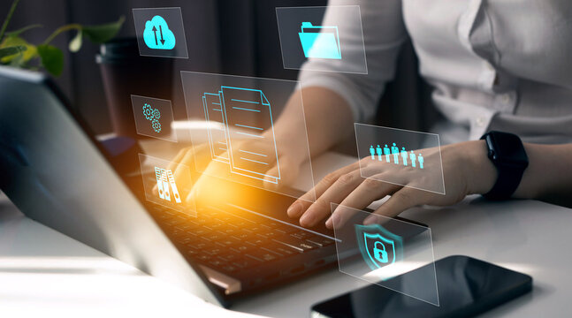 Business woman using a laptop with digital graph to document management. Software online documentation database and digital file storage system and file access concept.Enterprise resource planning.	
