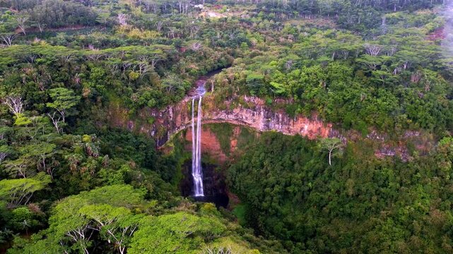 Fly over the breathtaking Chamarel Waterfall, hidden within Mauritius' lush rainforest. Perfect stock footage for travel, nature, or tropical-themed projects