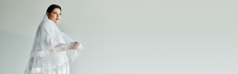 A stunning young woman in a white gown showcases her beauty, adorned with sparkling earrings on a...