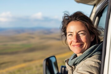 Smiling woman enjoying view from car on scenic trip