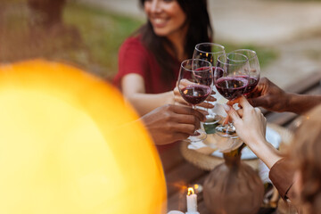 Friends toasting with red wine outdoors