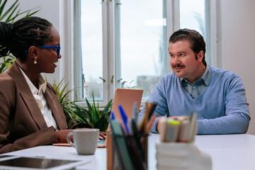Manager interviewing a male applicant in the office