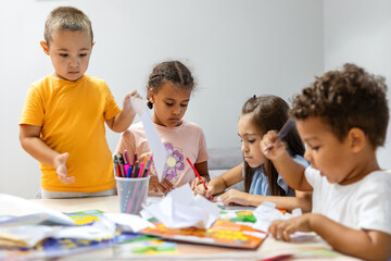 Children engaged in colorful creative arts and crafts.