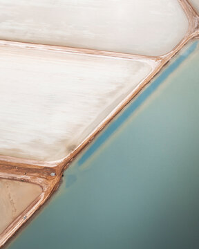Aerial view of serene salt marshes with geometric patterns and tranquil water, Useless Loop, Australia.