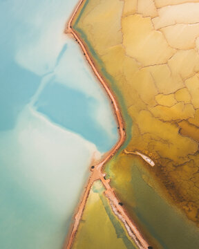 Aerial view of beautiful salt marshes with vibrant patterns and tranquil water, Unknown Island, Useless Loop, Western Australia, Australia.