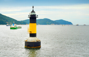 Lighthouse and boats in Songdo beach, Busan, South Korea.