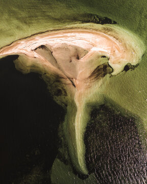 Aerial view of tranquil Whale Bone Point with serene coastline and unique patterns of sand and water, Denham, Australia.