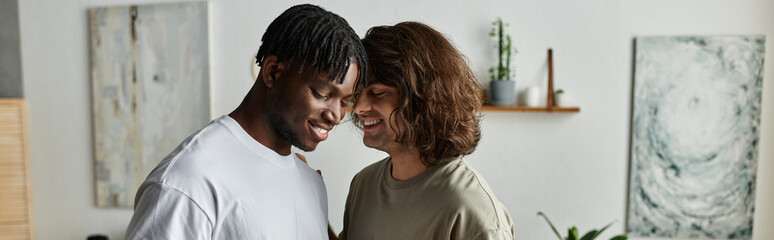 A joyful gay couple smiles at each other, enjoying a quiet moment together indoors.