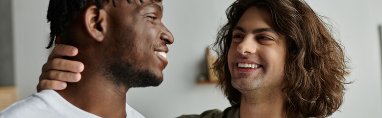 Fototapeta premium A loving gay couple embraces each other, radiating joy in their cozy home atmosphere.