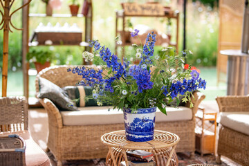Vibrant Blue Floral Arrangement on Rustic Wicker Table