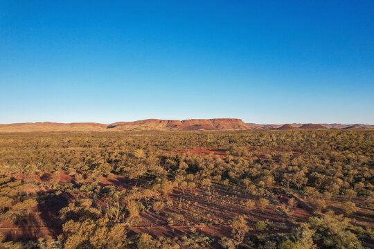 Aerial view of rugged desert landscape with rock formations and vast open space, Paraburdoo, Australia.