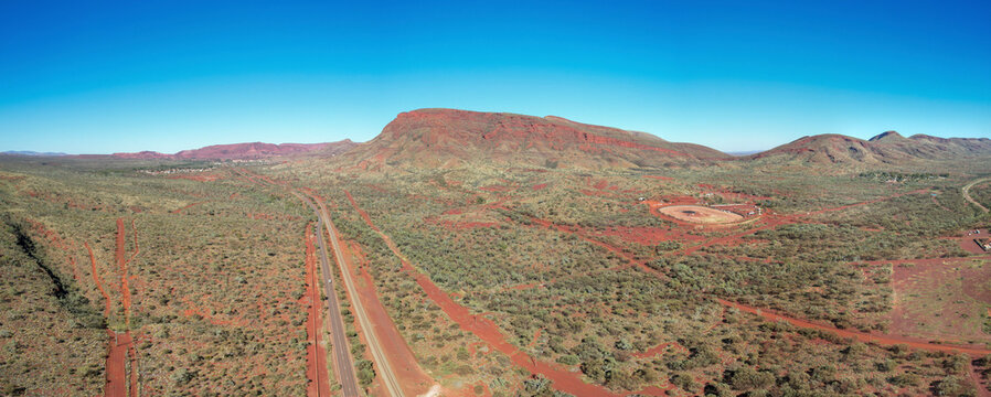 Aerial view of Mount Nameless, Mount Tom Price, and Mount Samson in a vast and rugged desert landscape, Tom Price, Australia.
